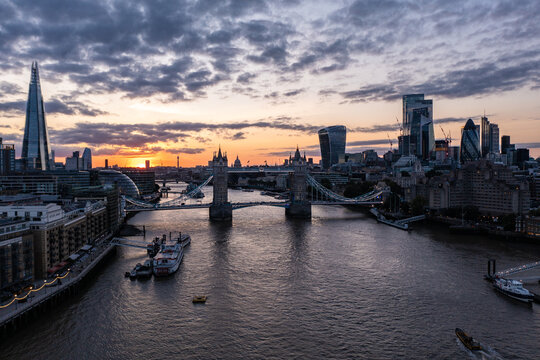 Tower Bridge over Thames River surrounded with buildings in London