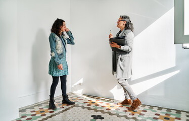 Real estate agent showing to woman while standing in rental apartment