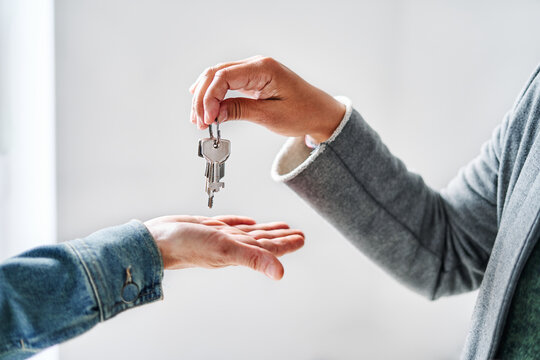 Real Estate Agent handing over the keys to the apartment to the client