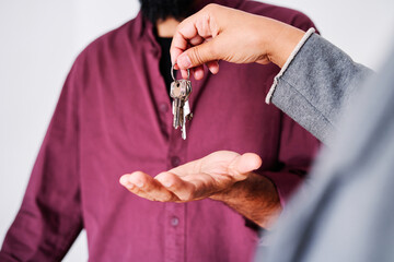 Real Estate Agent handing over the keys to the apartment to the client