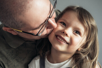 Portrait of father and daughter at home.