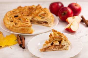 autumn apple pie and a slice of pie. Apple pie, cinnamon, apples and autumn leaves