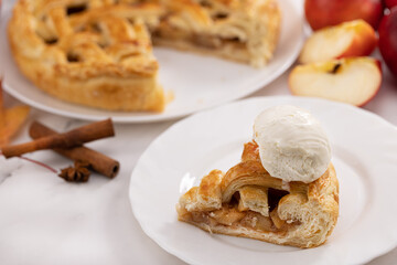 autumn apple pie and a slice of ice cream pie. Apple pie, cinnamon, apples and autumn leaves