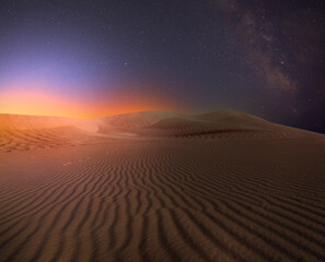 Scenic view of sandy desert under starry sky in night