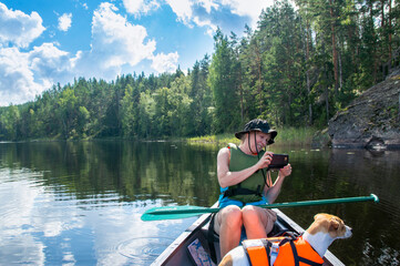 Woman canoeing at lake with dog