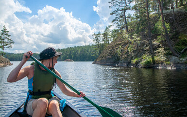 Woman canoeing at lake with dog