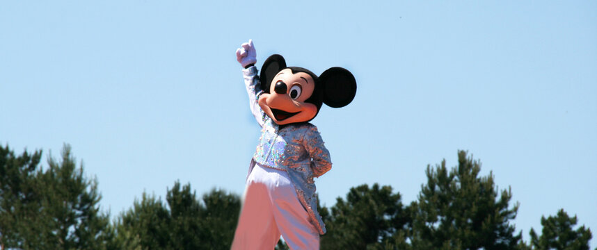 Mickey Mouse. Walt Disney character in a Disneyland parade. Disney World. Mickey in evening dress. Person disguised as Mickey in formal dress. The magic of Disney. Euro Disney. Disney Land Paris.