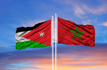 Jordan and Morocco two flags on flagpoles and blue cloudy sky