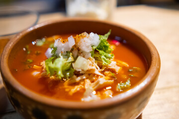 Clay bowl of delicious and traditional Mexican pozole