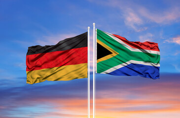 South Africa and Germany two flags on flagpoles and blue sky