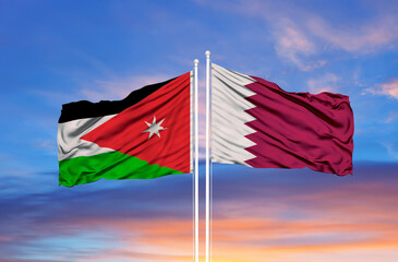 Qatar and Jordan two flags on flagpoles and blue cloudy sky