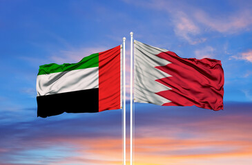 Beautiful national state flags of UAE United Arab Emirates and Bahrain together at the sky background