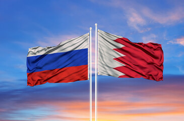 Bahrain and Russia two flags on flagpoles and blue sky