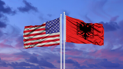 Albania and United States flag waving in the wind against white cloudy blue sky together. Diplomacy concept, international relations.