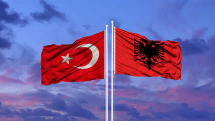 Turkey and Albania two flags on flagpoles and blue cloudy sky