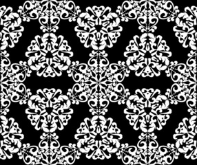Fototapeta premium White lace ornament on a black background. Abstract floral seamless pattern. Vintage texture for fabric, tile, wallpaper or packaging.