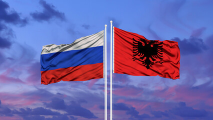 Russia and Albania two flags on flagpoles and blue cloudy sky