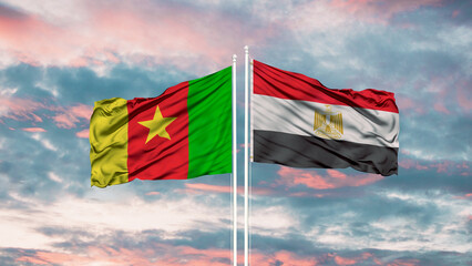 Egypt and Cameroon two flags on flagpoles and blue cloudy sky