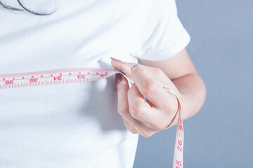 young girl measures her breasts