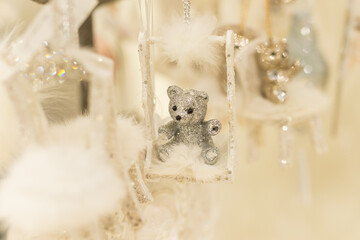 Close up of Christmas location with white jewelry bear toys on the branch