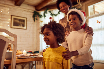 Playful African American family has fun while celebrating Christmas at home.