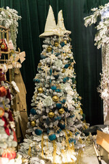 The holidays location with blue white and gold long Christmas tree