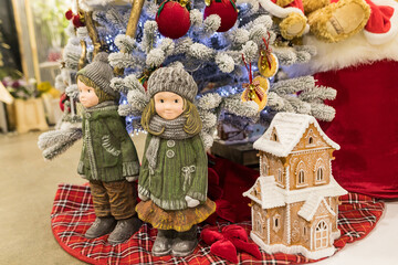 Close up of Christmas decorations with gingerbread house and dolls of a boy and a girl