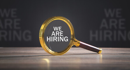 We Are Hiring message with a magnifying glass.