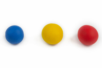 Plasticine, clay balls, handmade. Three primary colors. Isolate on a white background. Educational material for children.