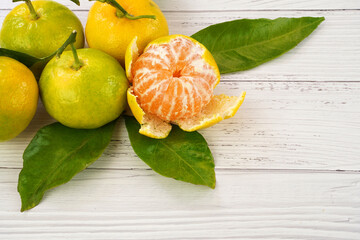 Fresh , green-yellow colors mandarin or tangerines. White woden background.