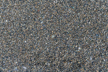 sea beach of small multi-colored pebbles as a natural background