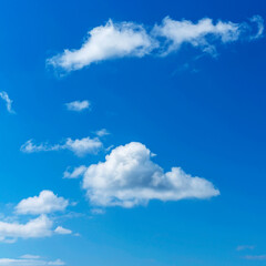 Naklejka na ściany i meble beautiful cumulus clouds against the blue sky as a natural background