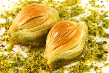 Turkish Midye Baklava  ( Mussel Shape Baklava ) with green pistachio nuts.  
