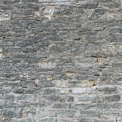 Old brick wall of different size sandstone bricks as a natural background