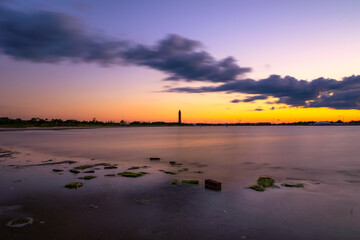 Pastel colors in the sky above the orange glow of dusk. Jones Beach, Long Island New York