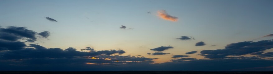 The evening sunset. Panorama. Purple clouds. Tragic gloomy sky.