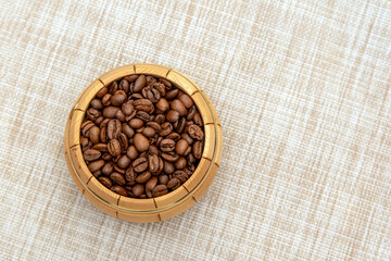Coffee beans in a small wooden barrel