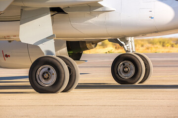 The plane is preparing to fly at the airport. Airplane on the runway at the airport. The turbine of the aircraft is warming up, the landing gear is preparing for flight. The plane flies in the sky.