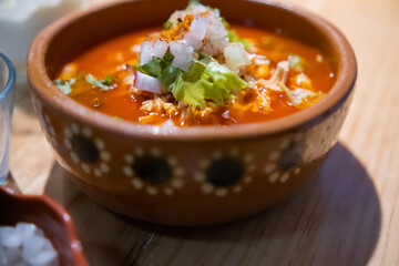 Clay bowl of delicious and traditional Mexican pozole