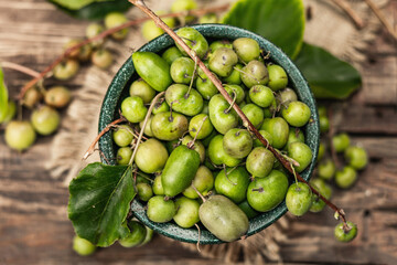 Harvest of ripe Actinidia arguta kiwi in a ceramic bowl