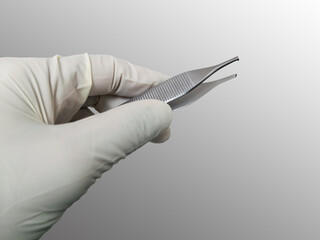 Surgeon Holding Adson Brown Forceps With Gloved Hand. Selective Focus