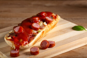 Mini pizza with sausages and tomato ketchup