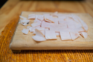 Fresh chopped turkey ham on a cutting board