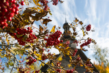 Autumn landscape. Yellow foliage on the trees and a rustic wooden church.