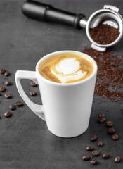 Relaxing latte coffee in white porcelain cup on stone table