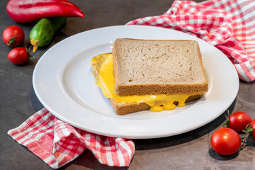 Cheddar toast in white porcelain plate on dark stone table