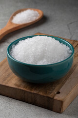Bowl with coarse salt on the table.