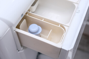 A modern washing machine empty clean drawer, a washer container for detergent and laundry conditioner