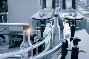 Empty glass bottles on the conveyor. Factory for bottling alcoholic beverages. Production and bottling of alcoholic beverages concepy.