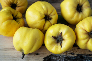 fresh yellow quince on a wooden table